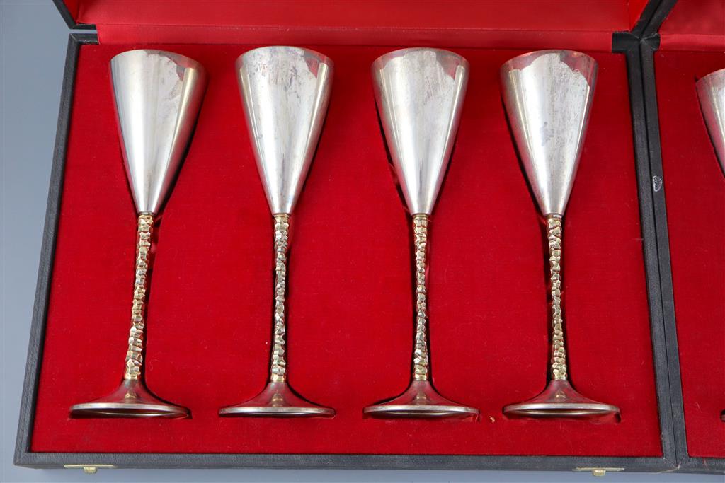 A set of six modern Stewart Devlin parcel gilt silver goblets (Senior Falcon Award 1979 & 1980) in two fitted cases (4 & 2),